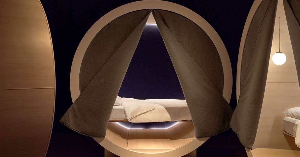 A sleeping pod with brown curtains in the Dreamery by Casper...