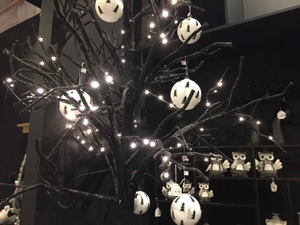 Black branches decorated with white Christmas baubles....