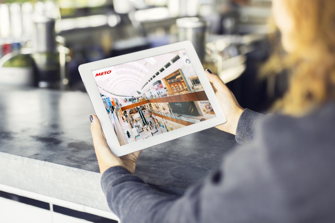 A woman holds a tablet in her hands. The website of Meto International GmbH is...