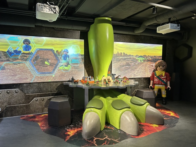 A large dinosaur foot with two screens and a game station....