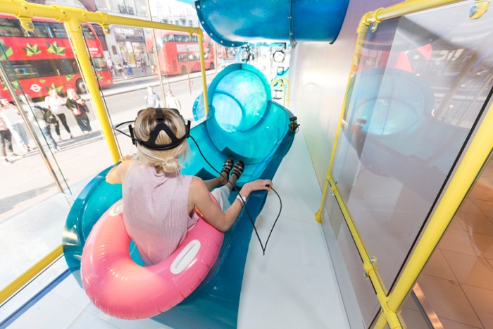 Woman in a slide with VR glasses; copyright: Topshop...