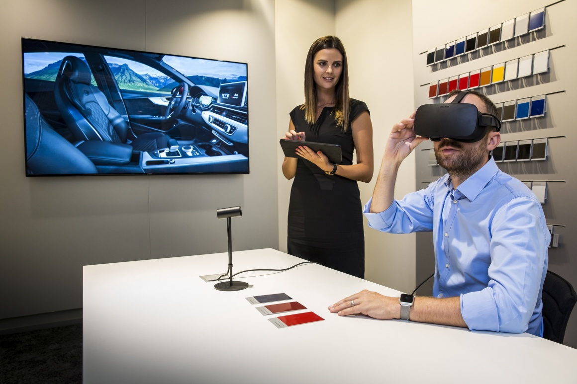 Customer with VR glasses in front of screen with interior car design;...