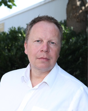 Man in a white shirt looking into the camera