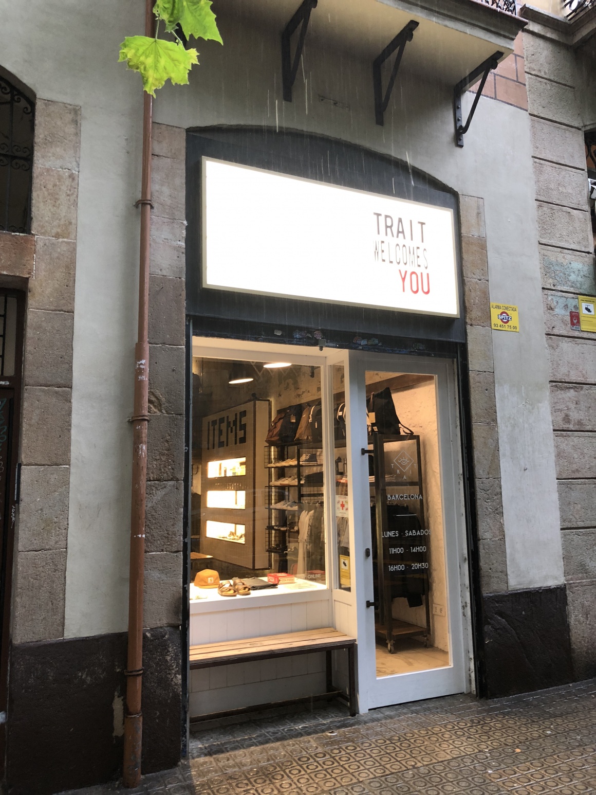 Entrance door with illuminated advertising to a small clothing shop...