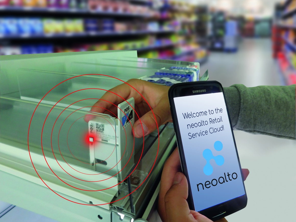 A person holds a smartphone on which the neoalto Retail Service Cloud can be...