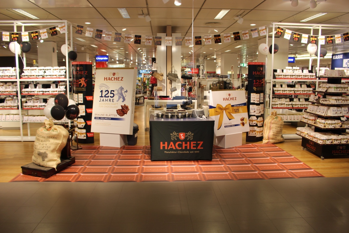 An advertising space for various chocolates in a department store with a floor...
