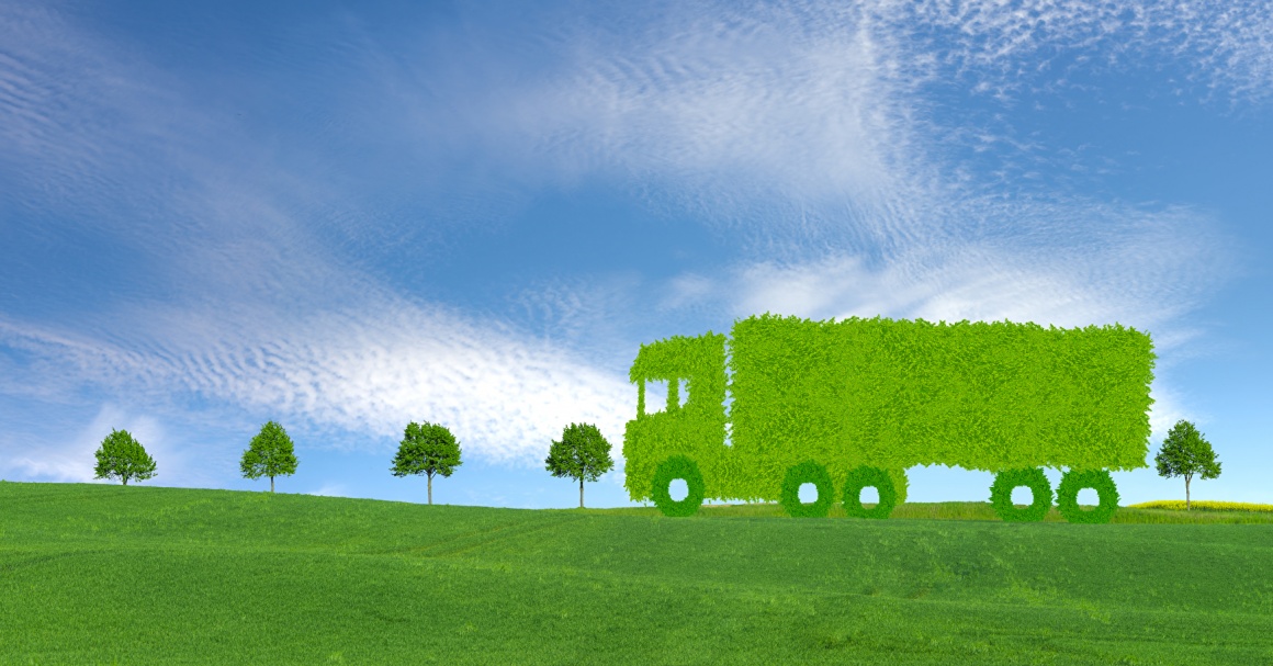 A truck made of grass driving through a green landscape...