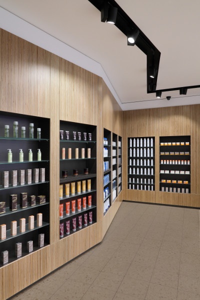 A pharmacy with shelves and ceiling lights