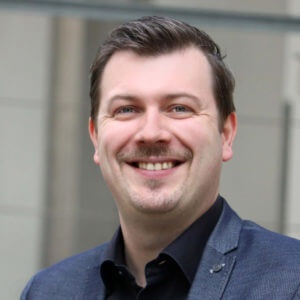 A smiling man with brown hair