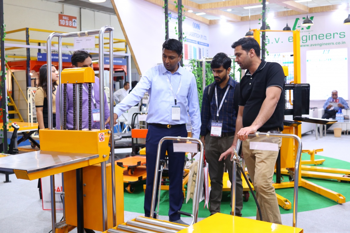 A guy showing a machine to two men