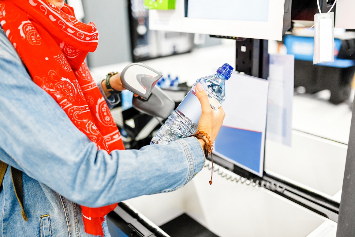 Woman at self-service checkout