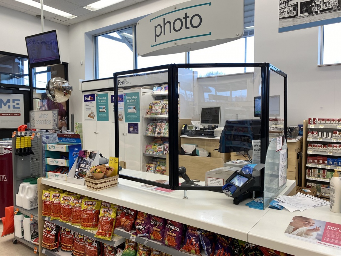 A  counter in a store with a transparent shield