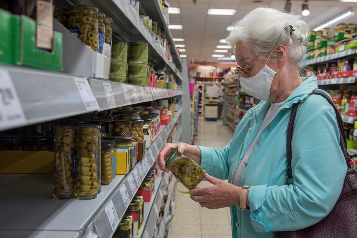 Oler lady with face mask in a supermarket