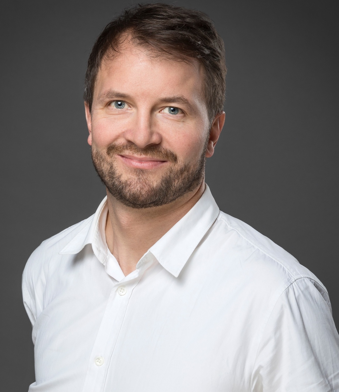 Man in white shirt against grey background