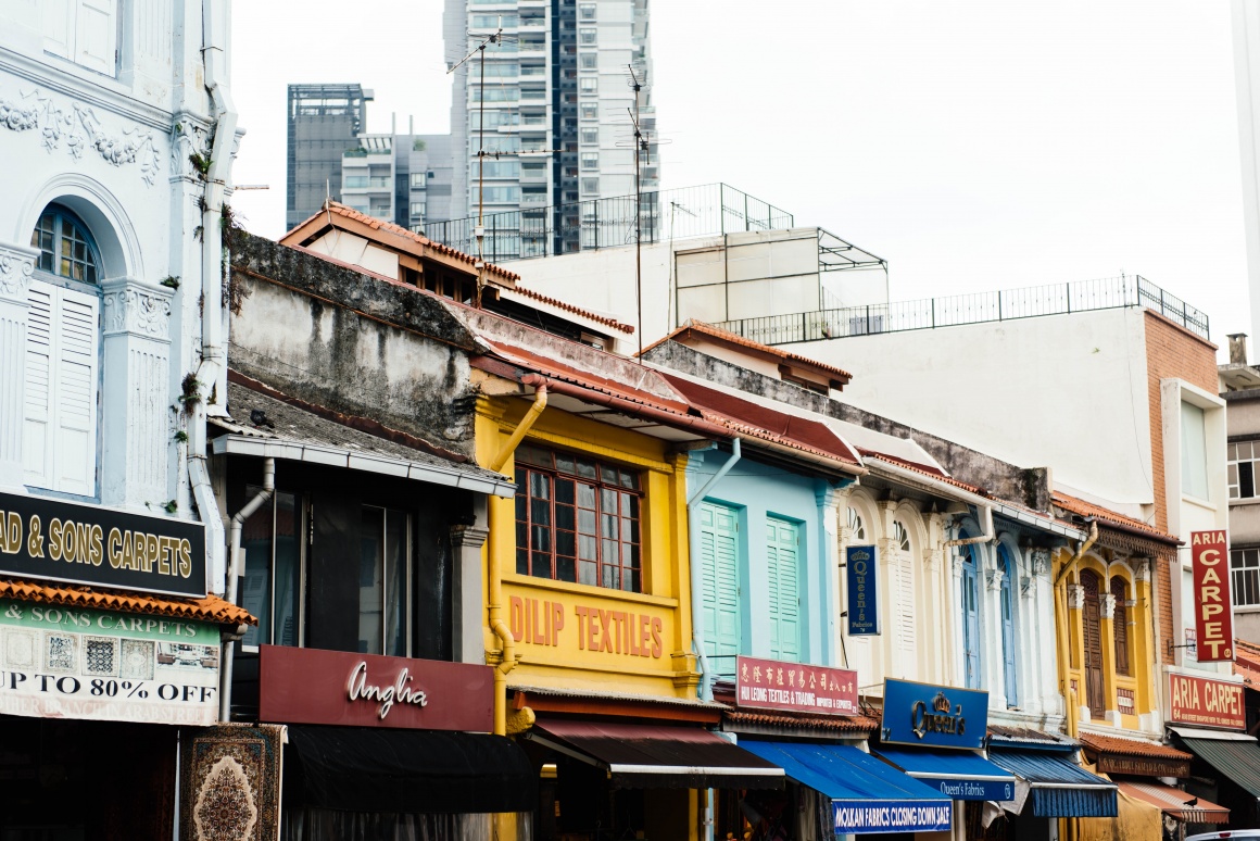 Several store fronts in different houses in a city