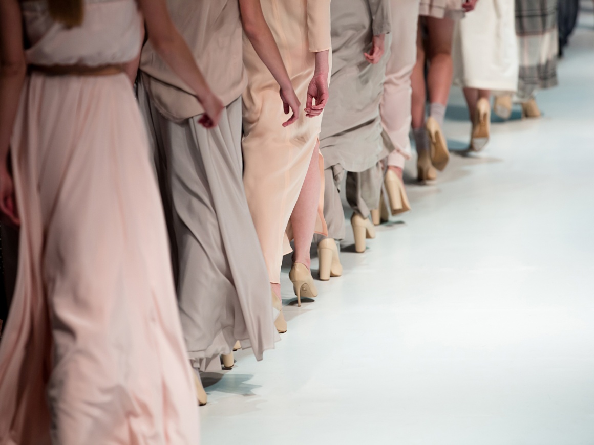 Models in dresses walking down a runway
