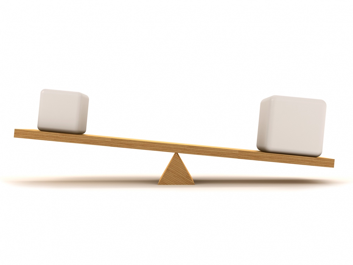 A simple wooden seesaw in imbalance with white packets on it...