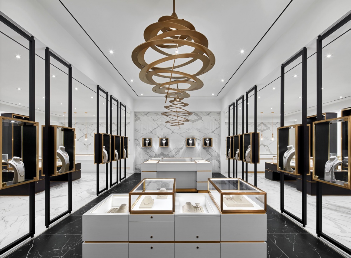 A jewelry store with white walls, golden decoration and black showcases...