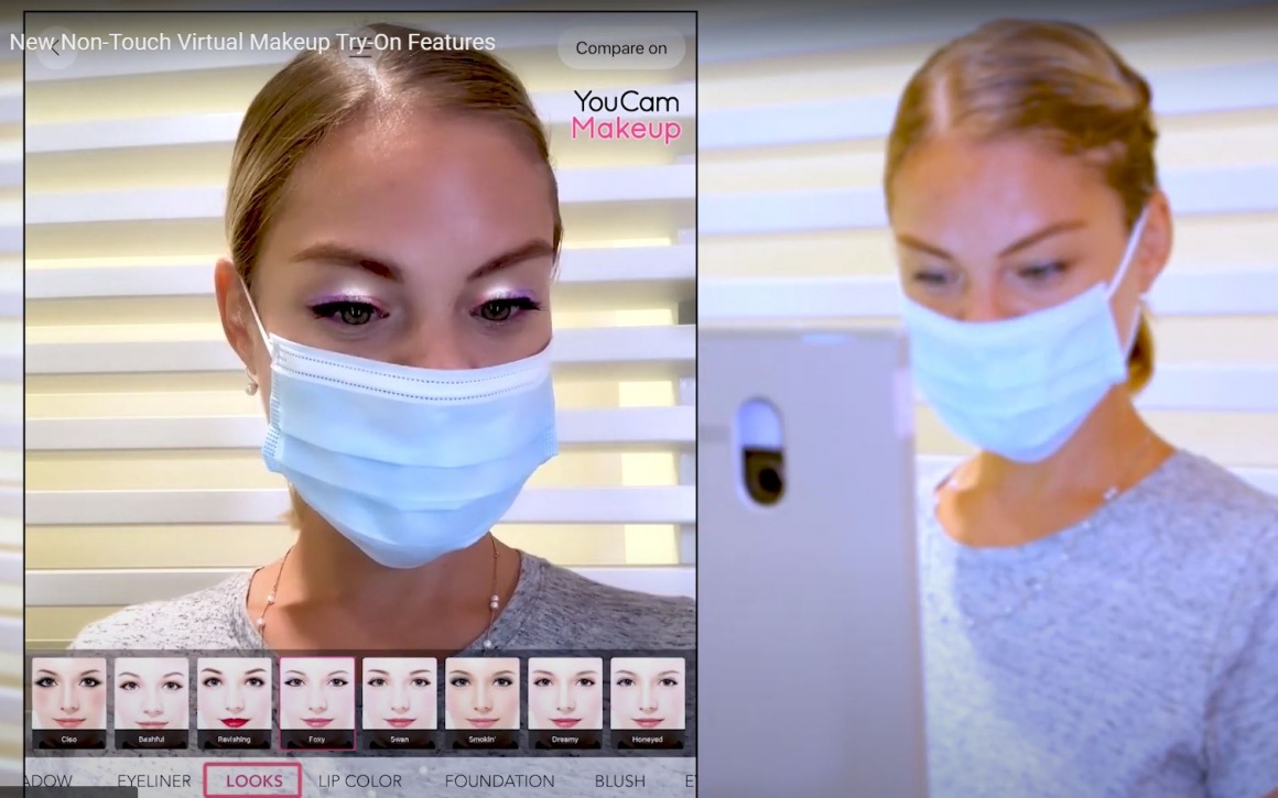 A woman with a face mask using a virtual makeup try on tool...