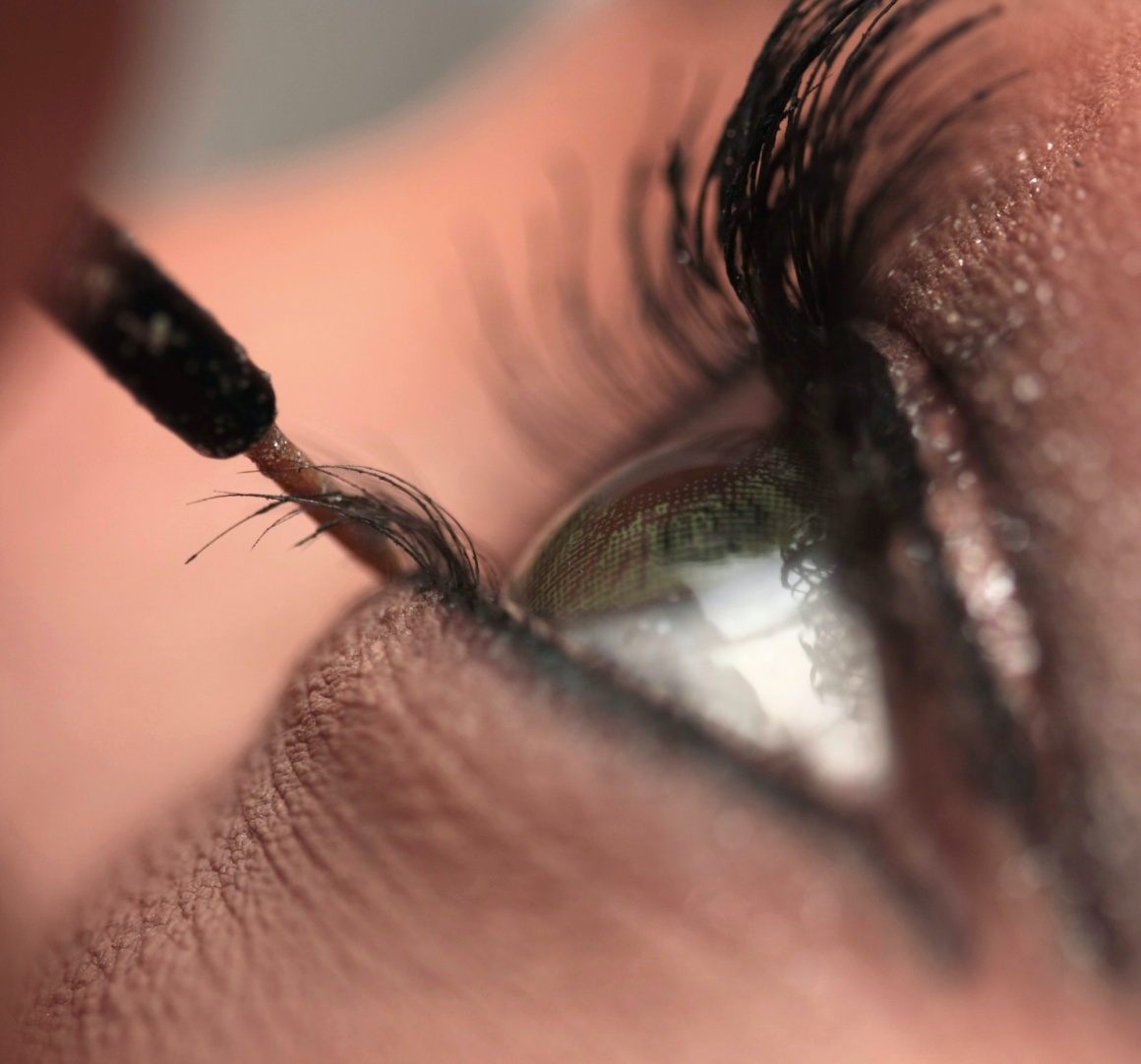 Close up of a woman’s eye applying make-up