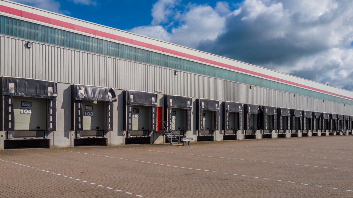 A warehouse with many empty loading docks for trucks...