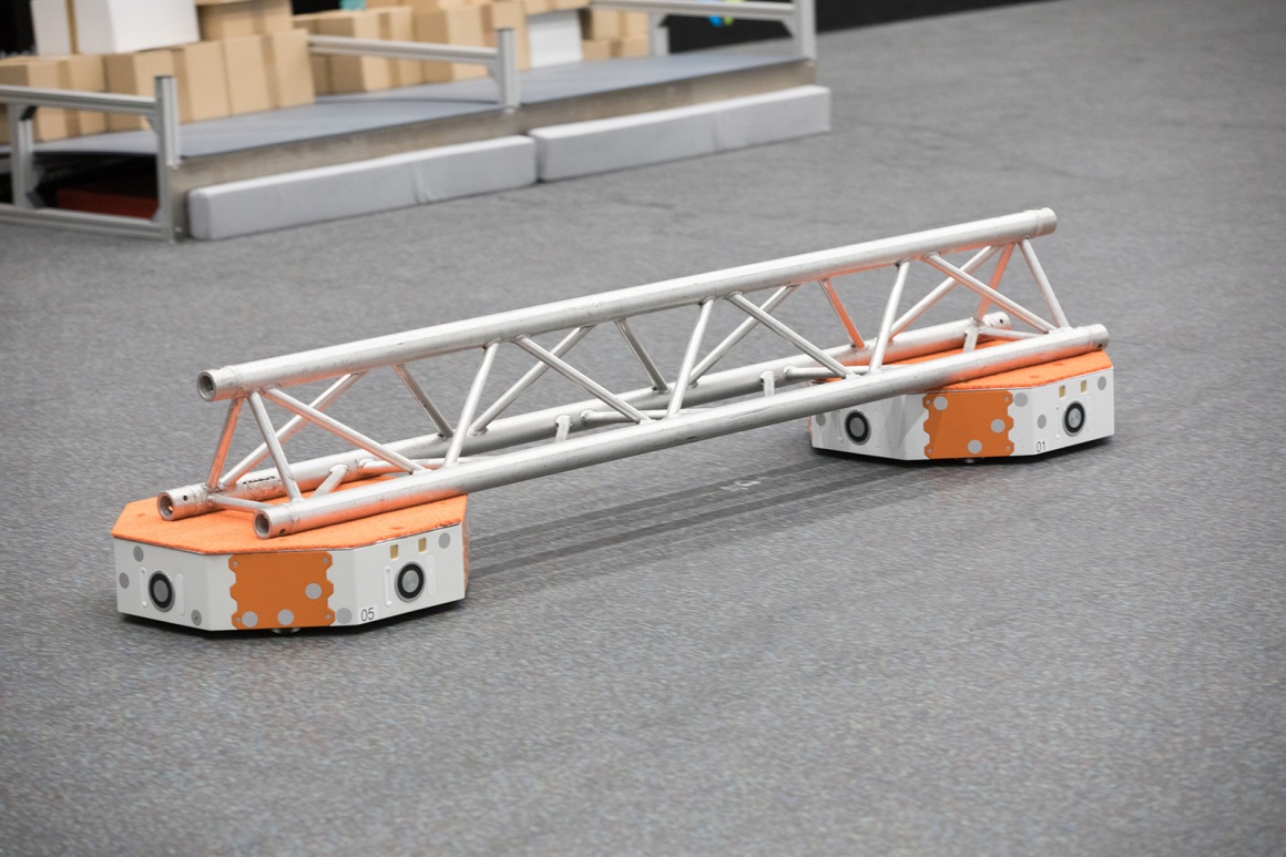 Autonomous transport vehicle transports a steel beam...