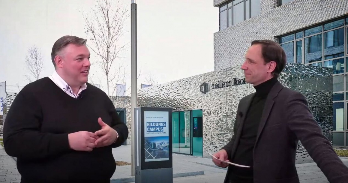 Two men talking in front of a virtual background