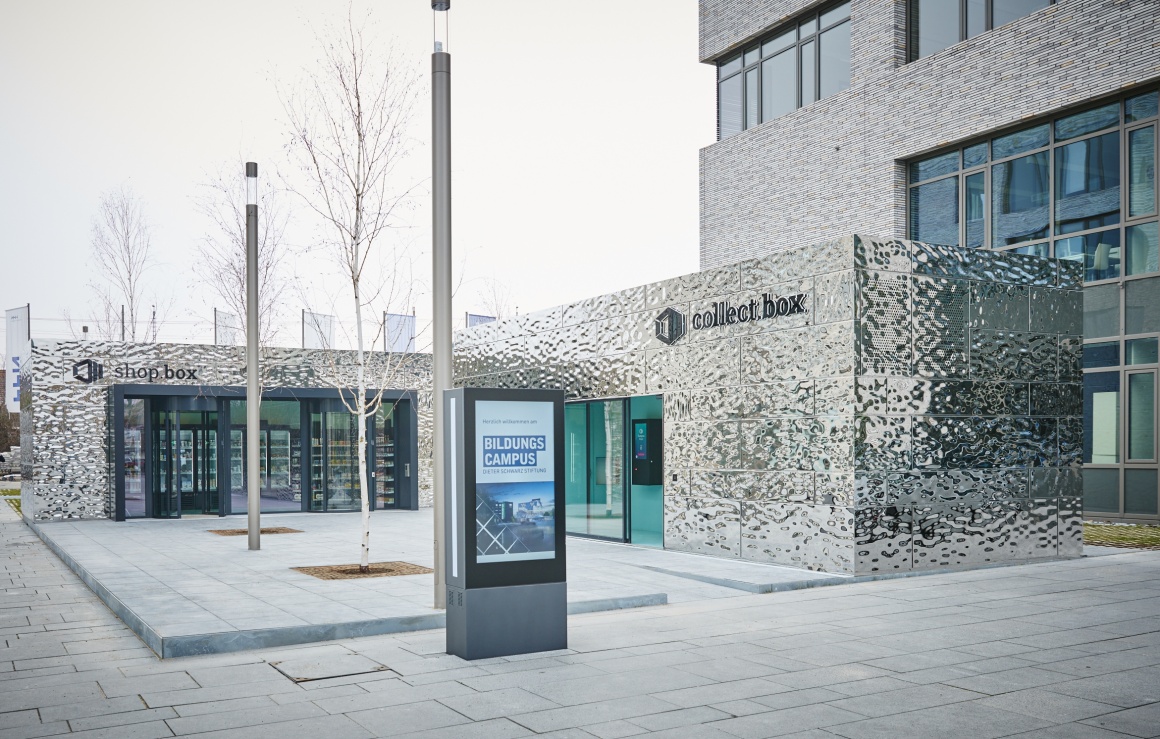 Two small silver buildings on a campus