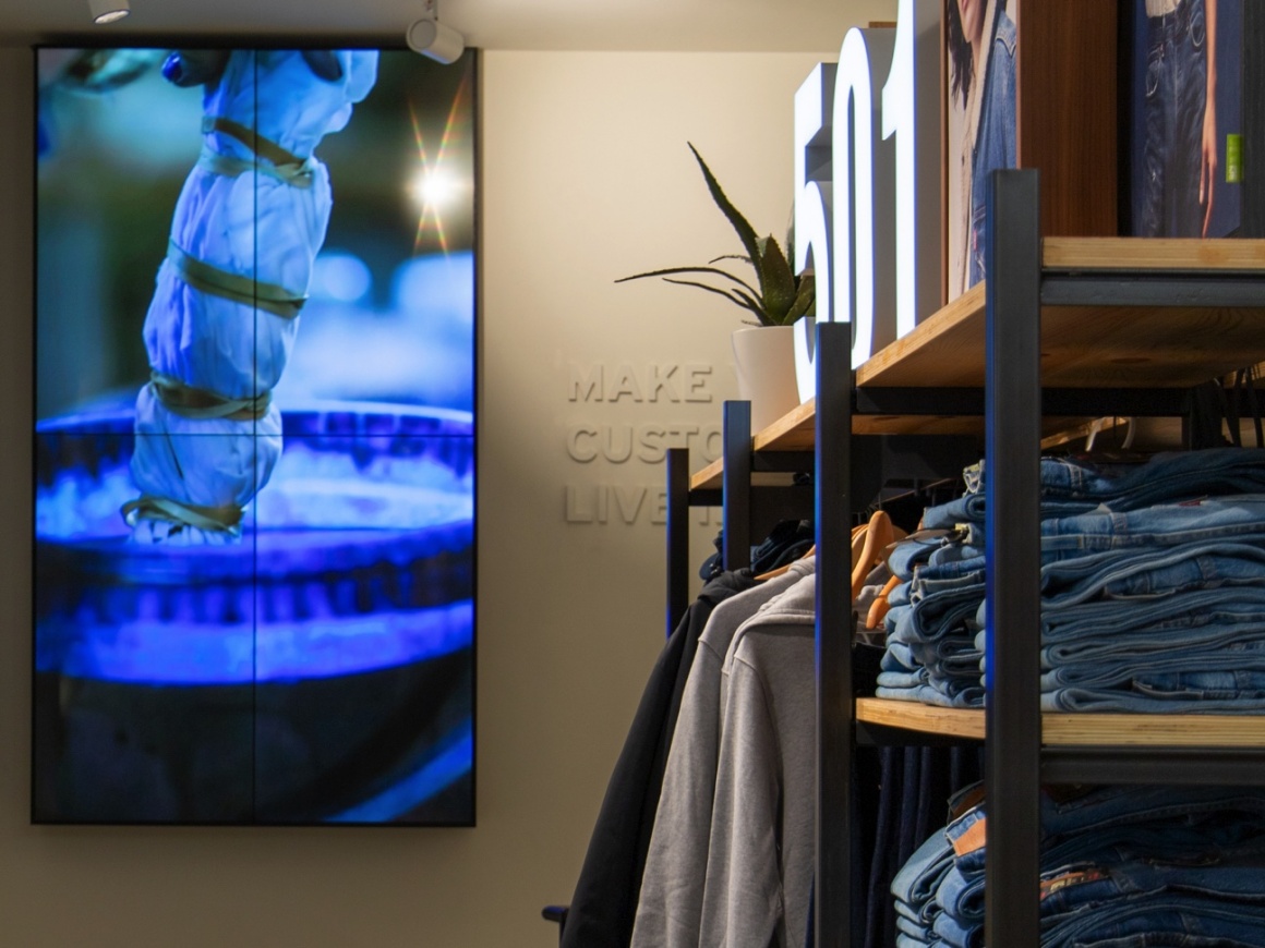 A digital screen in a jeans store