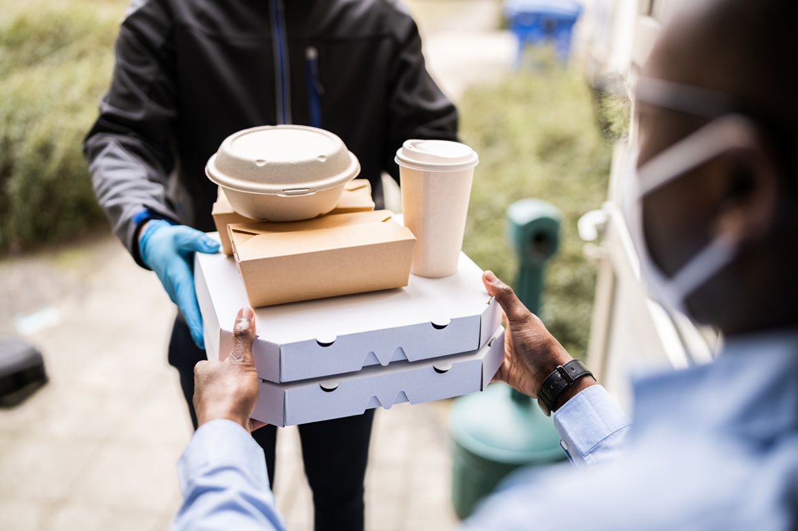 man hands over ordered food