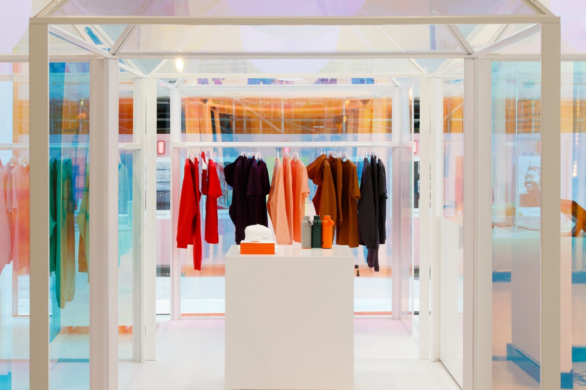 colorful clothes hang from a clothing rail