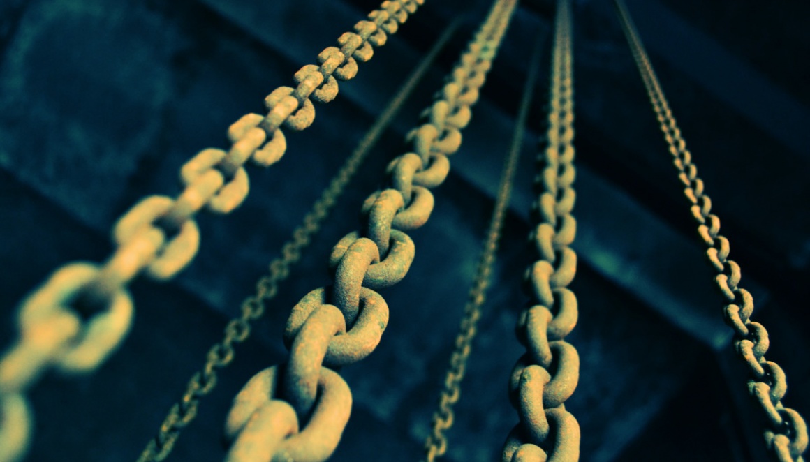 Several steel chains hang down from above