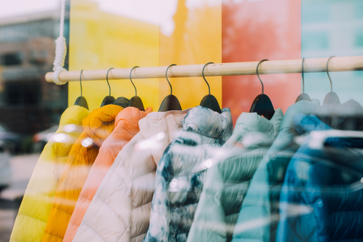 colorful jackets hang on a clothes rail